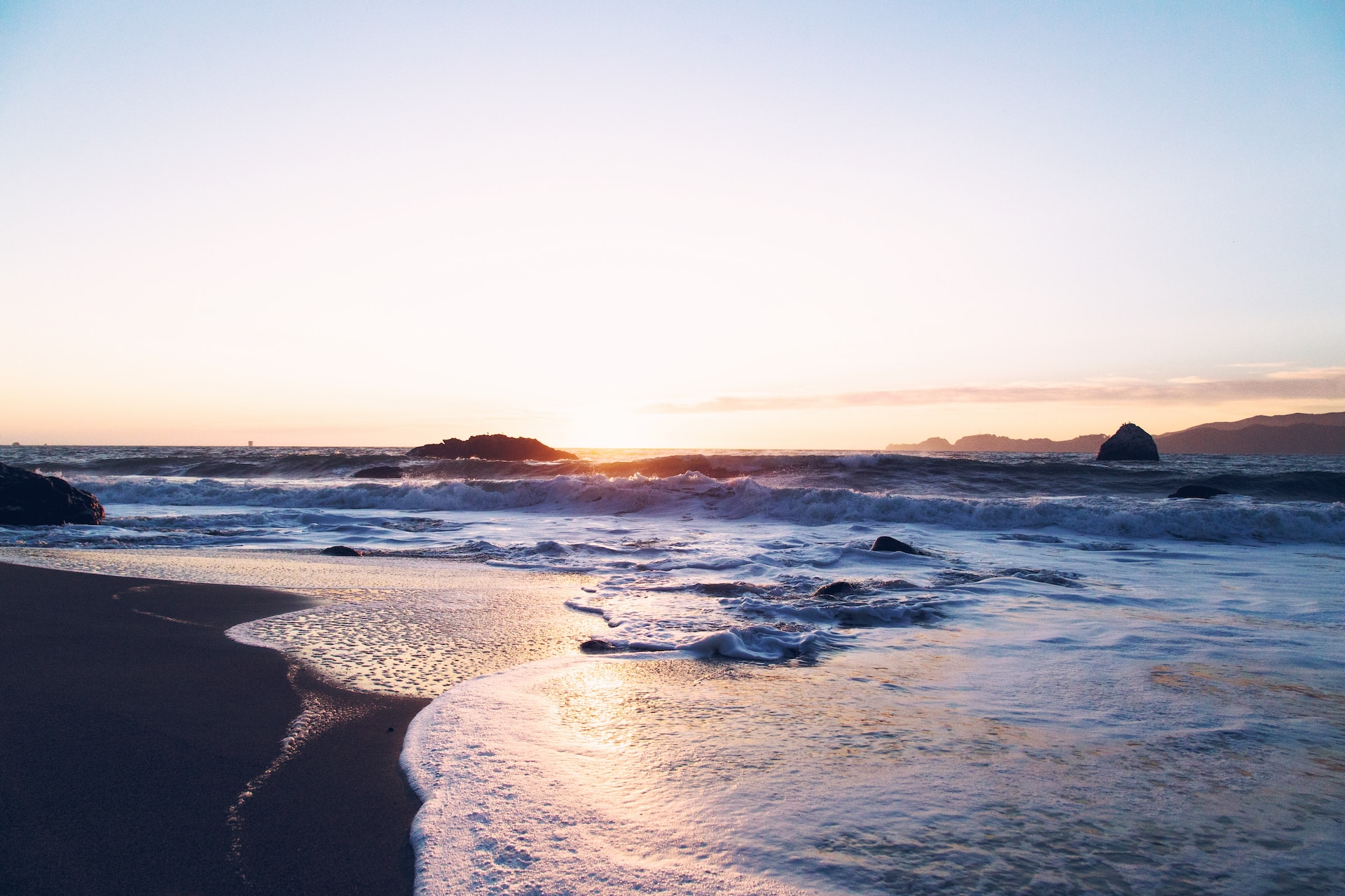 A picture of a beach at sunset.