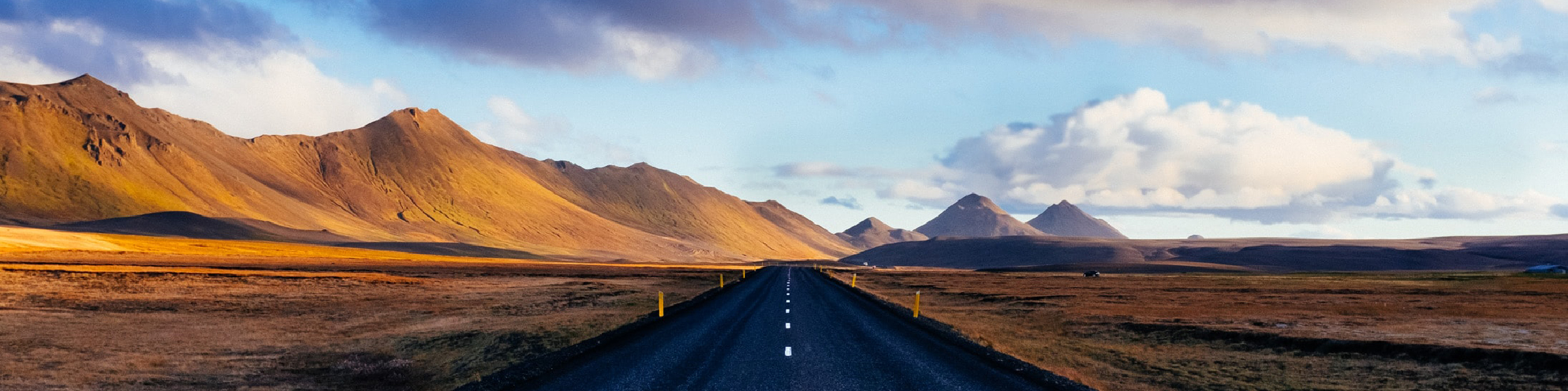 An open road crossing a desert. 