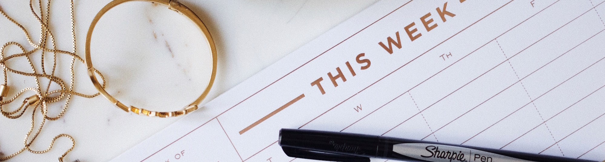 A calendar and pen on a desk.