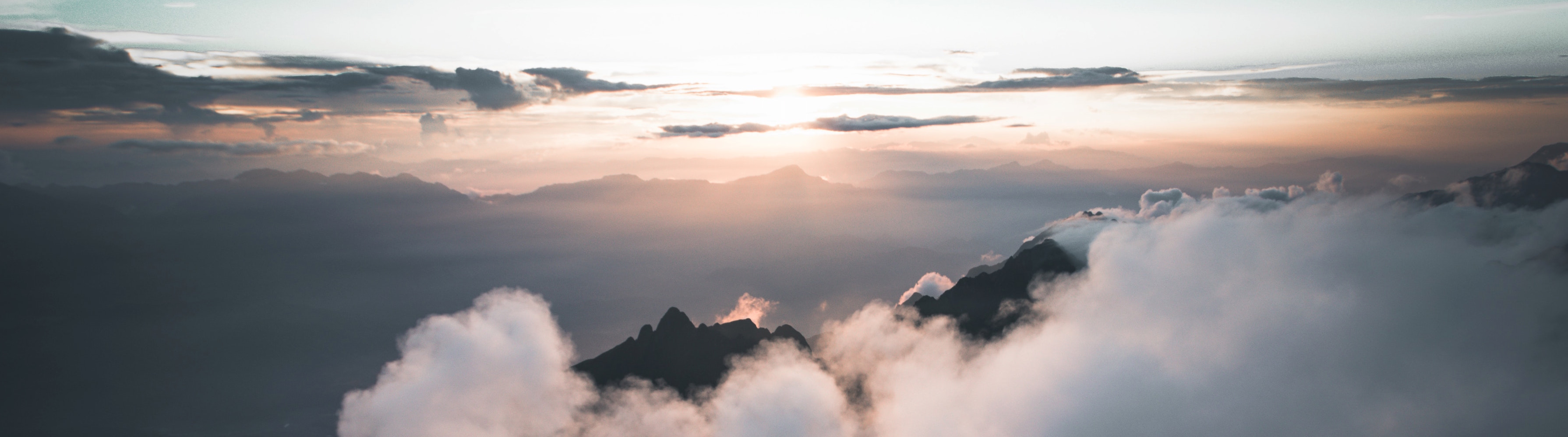 A sunrise over a cloudy mountaintop.