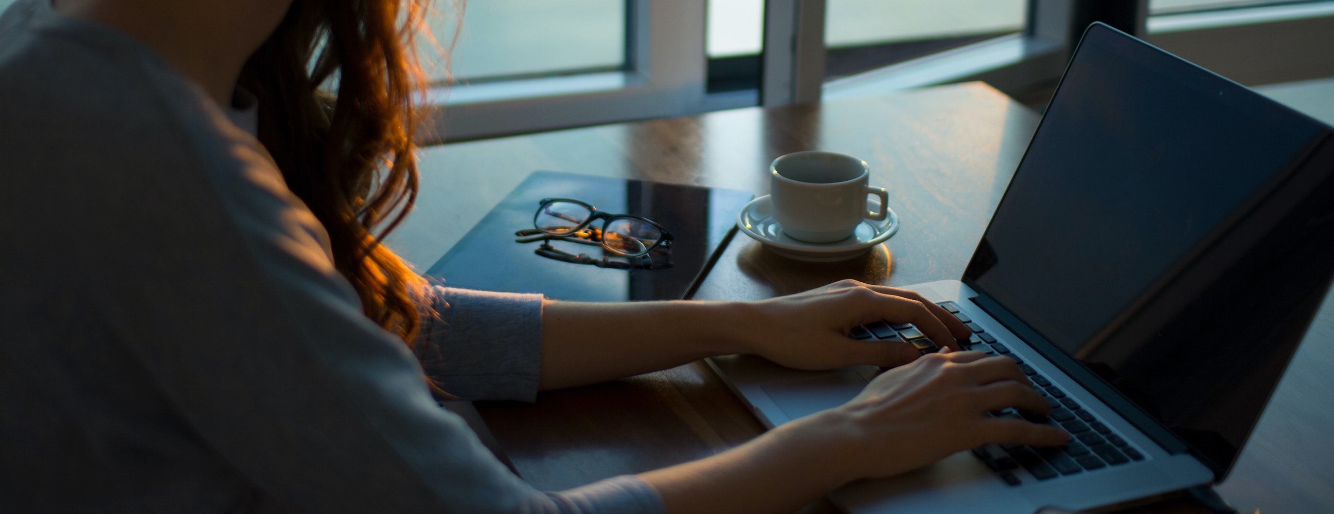 A woman working from home on her laptop.