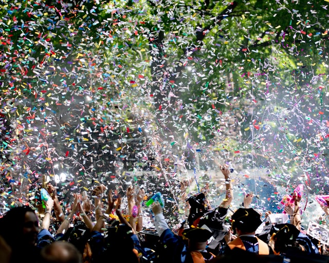 Confetti falling on graduates.