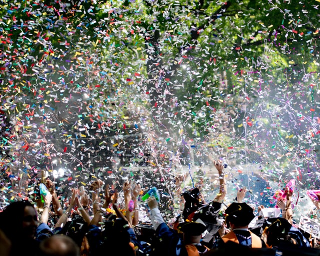 Confetti falling on graduates. 