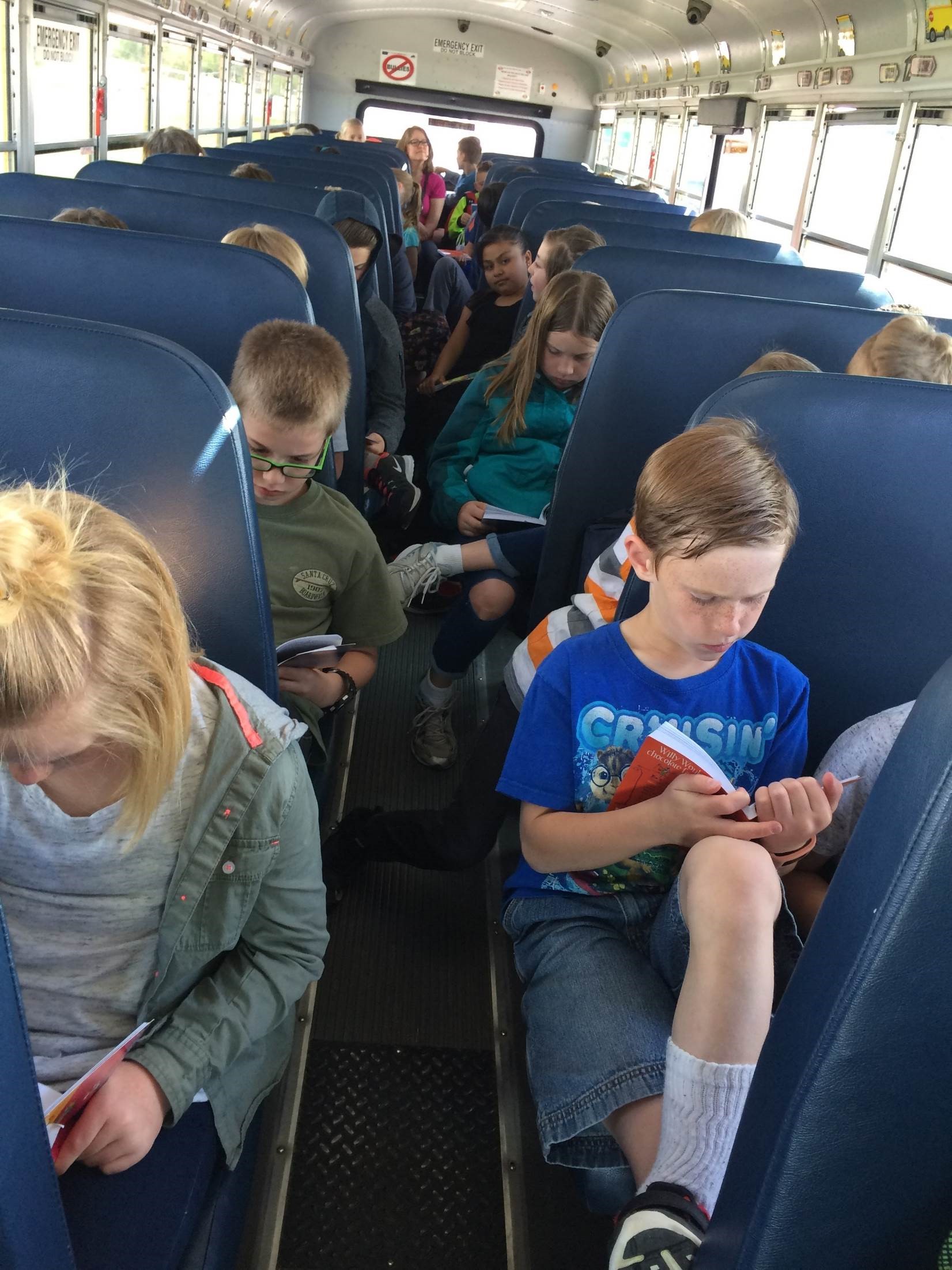Students reading on the bus