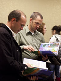 Two men looking at books