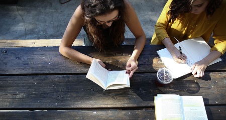People reading at a table.