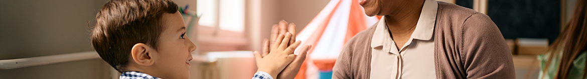 teacher giving a young student a high five