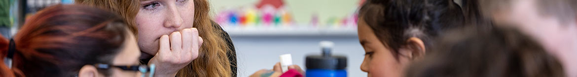 Teacher listening intently to a young student