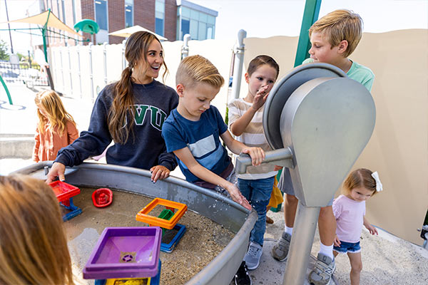 Teacher playing with students outside