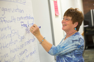 Teacher writing on white board