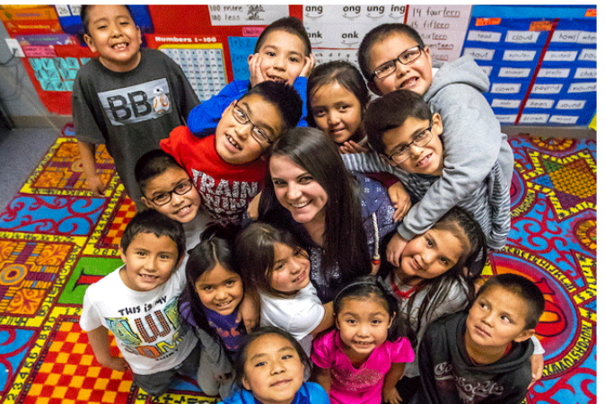 Kids huddled around their teacher