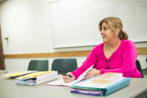 Student sitting at table with books