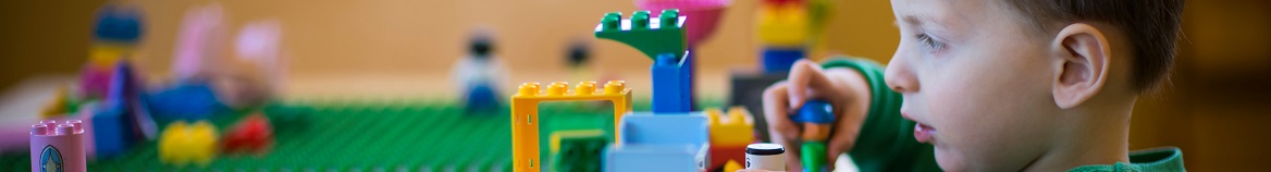 Young boy playing with legos on a table