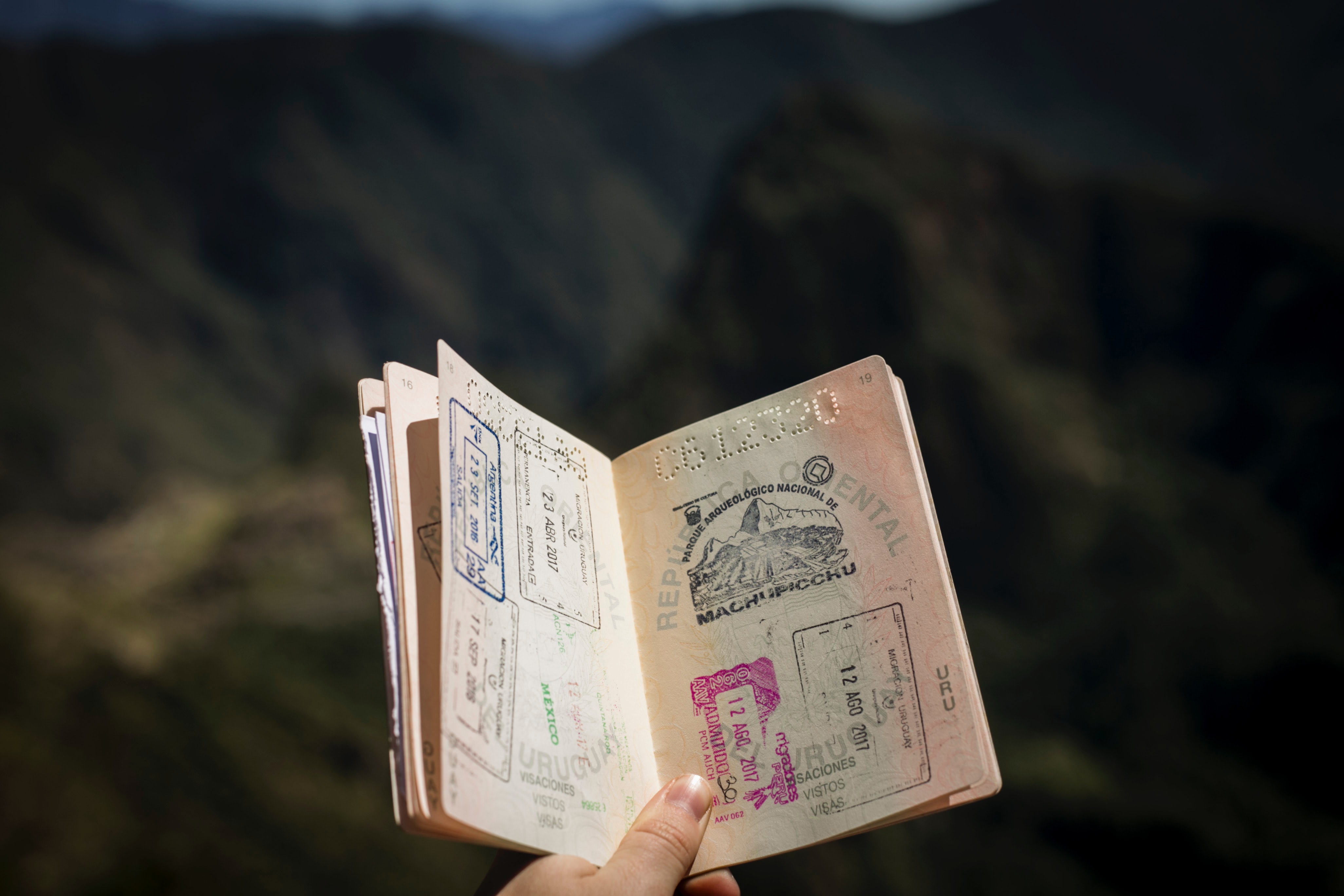 Passport with mountains in background - Photo by Agus Dietrich on Unsplash