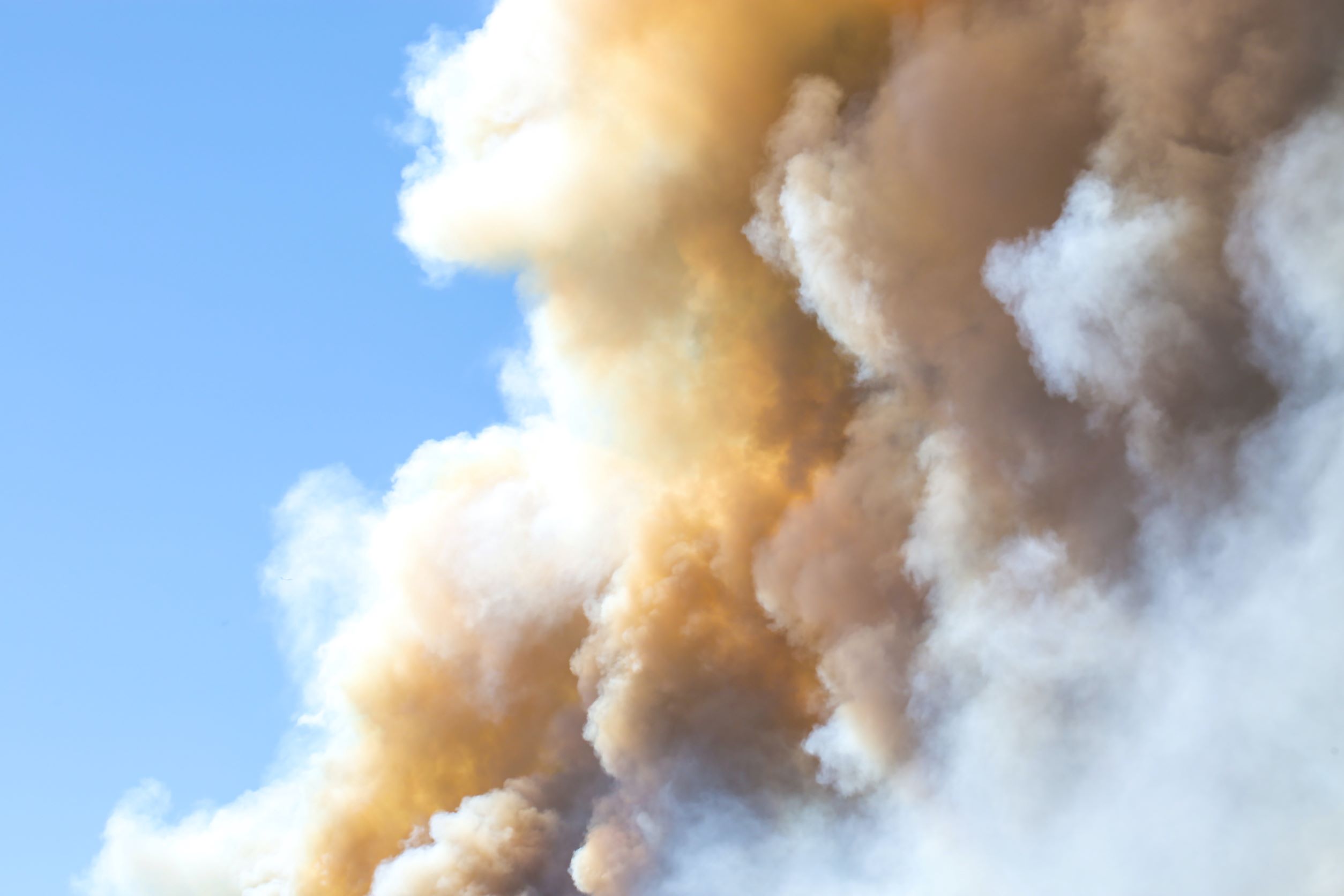 Smoke against blue sky