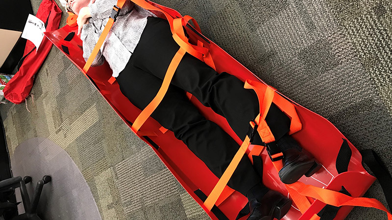 Person in UVU Med Sled Evacuation Device