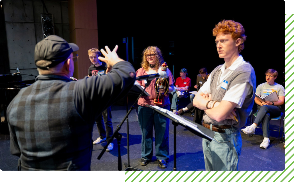 Musical director in front of theater students