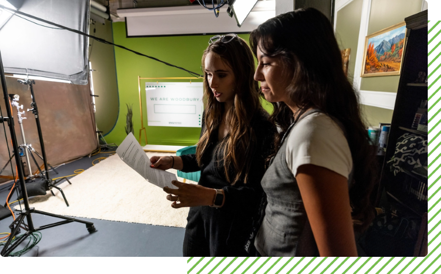 students reviewing a movie script on set