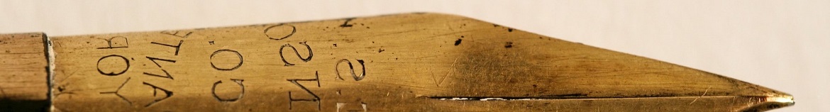 An old wooden pencil with words carved into it.