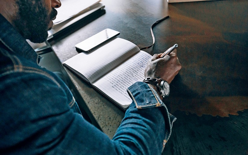 Man writing in a book