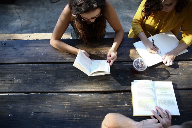 Group reading at an outdoor table