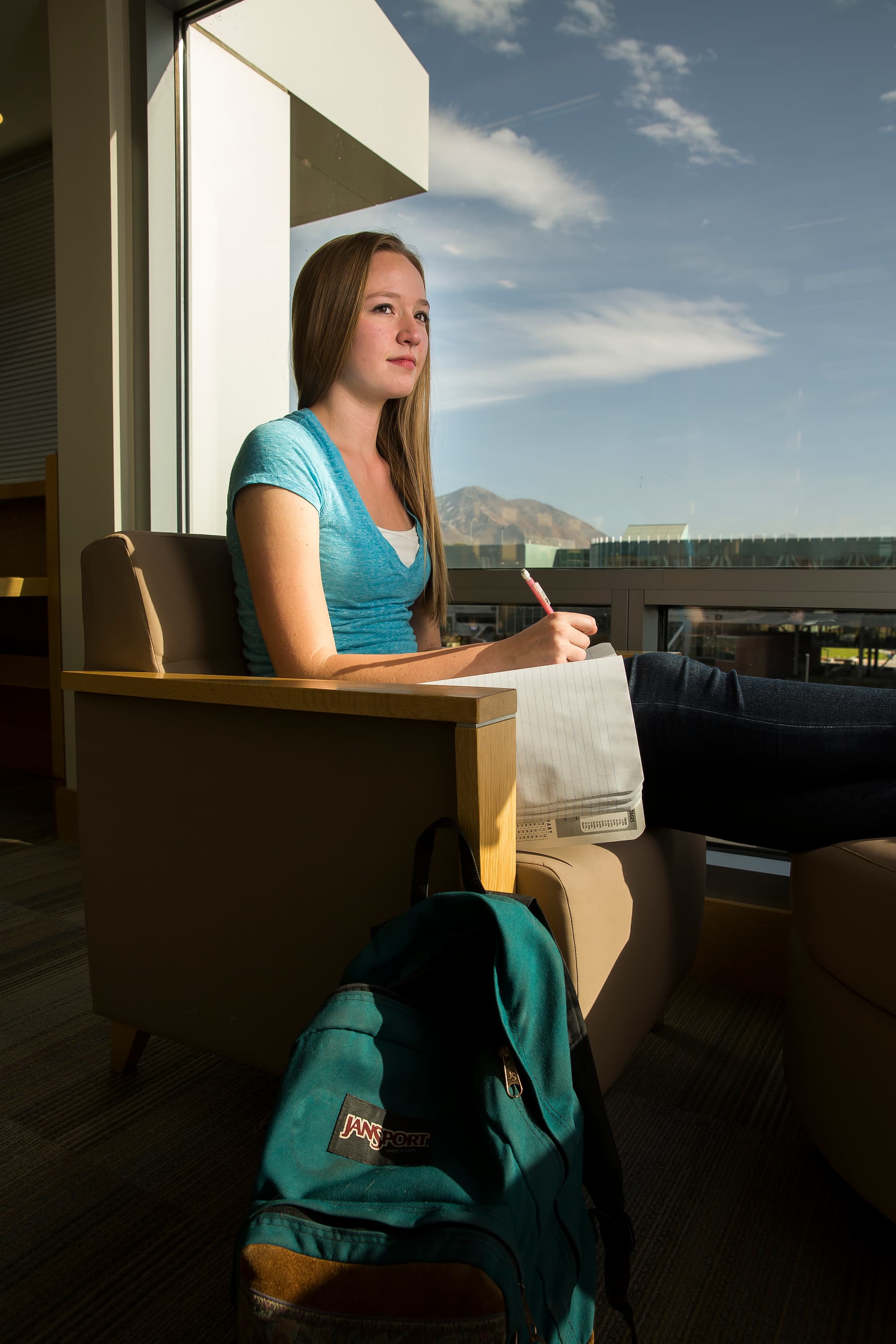 Girl sitting in chair writting in a notebook