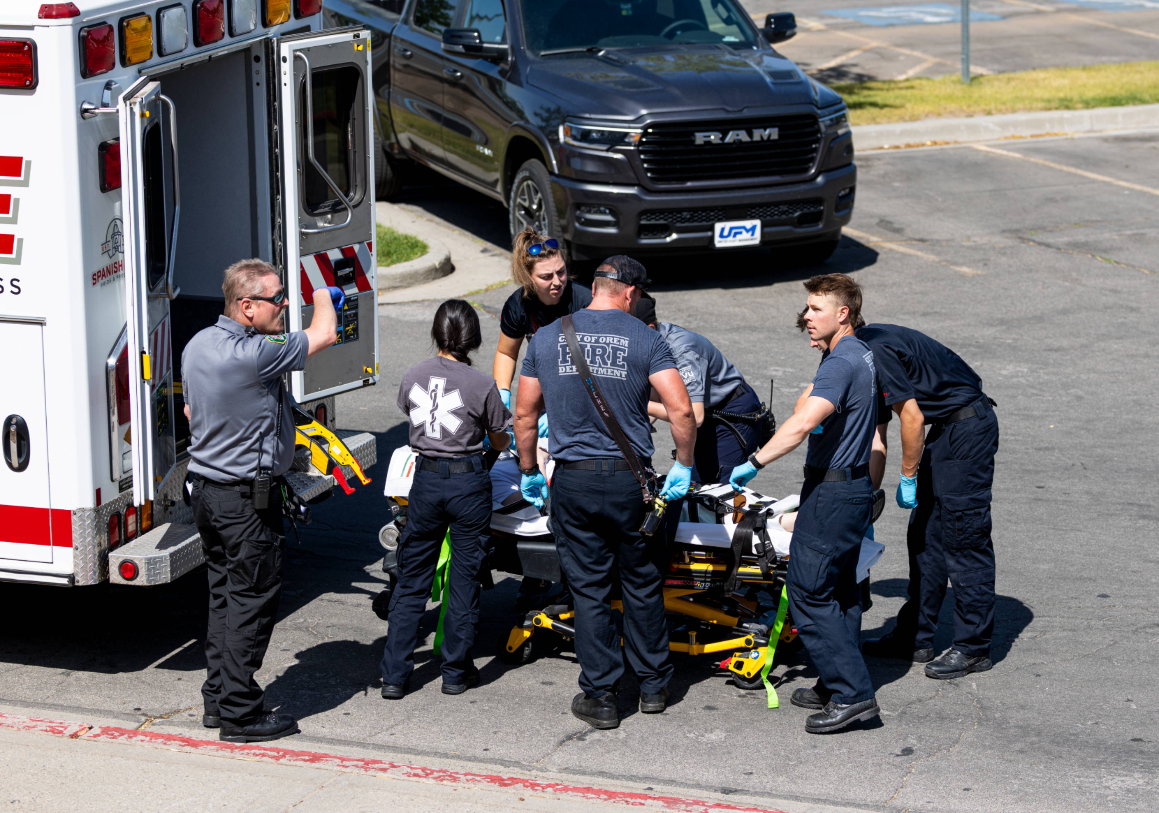 EMTs loading a patient into an ambulance
