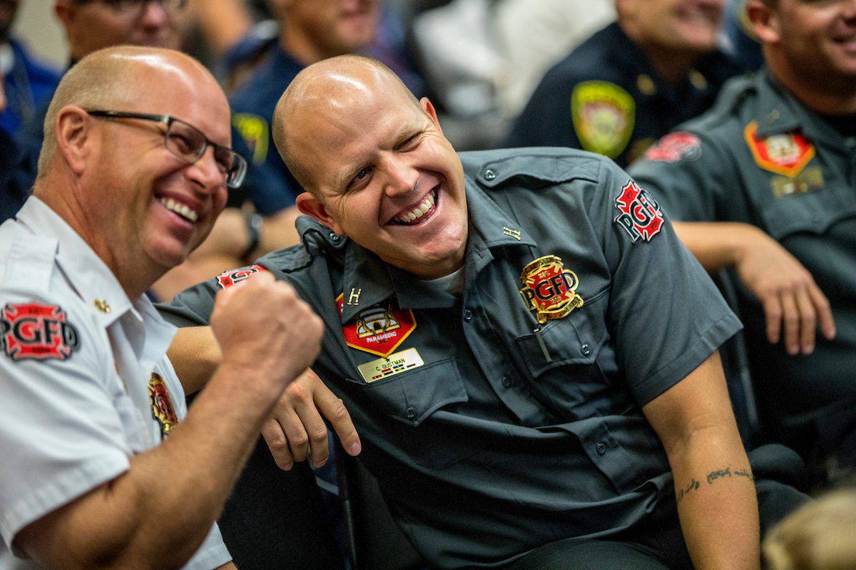 two men in uniform, the men are laughing
