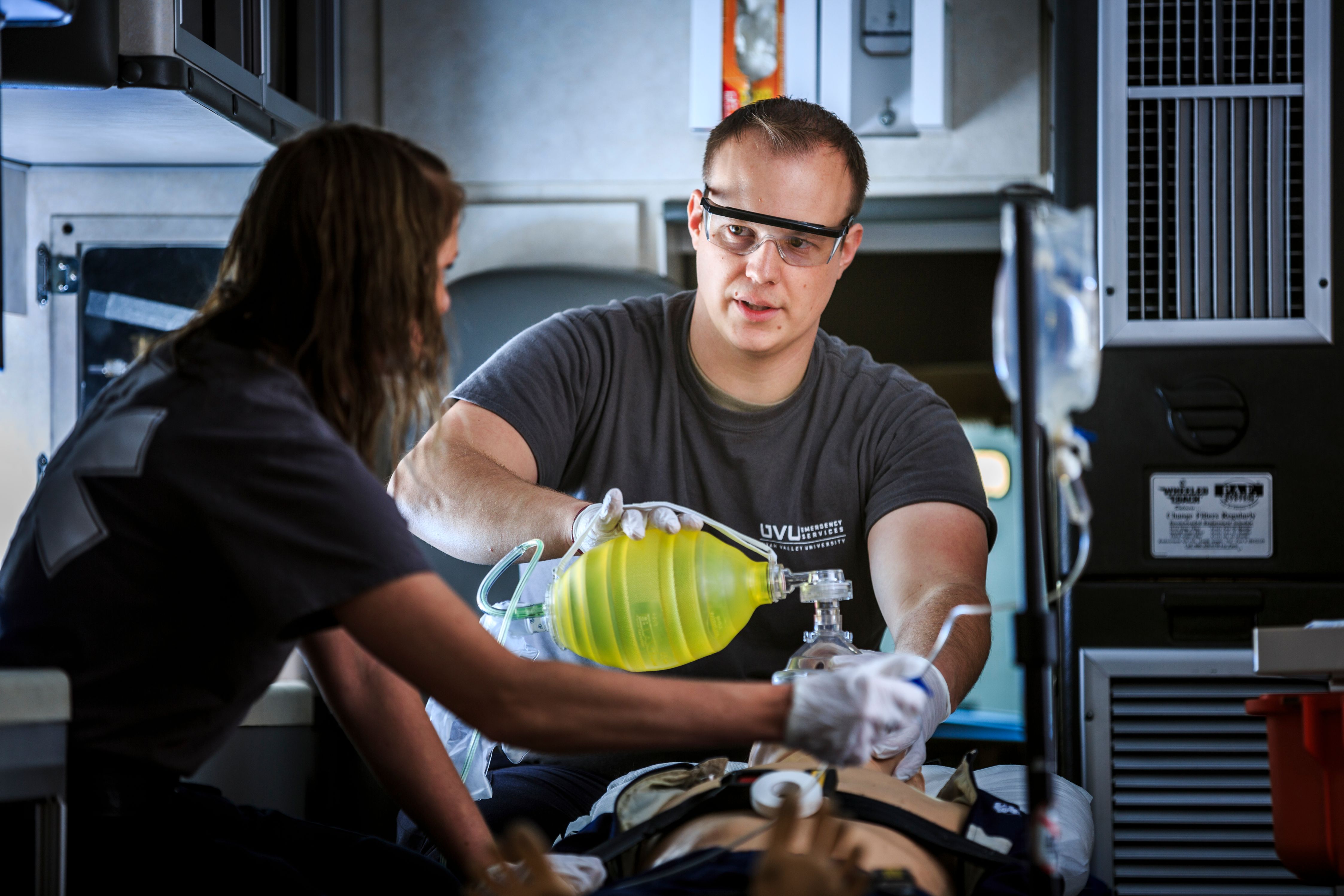 Two EMT workers loading equipment