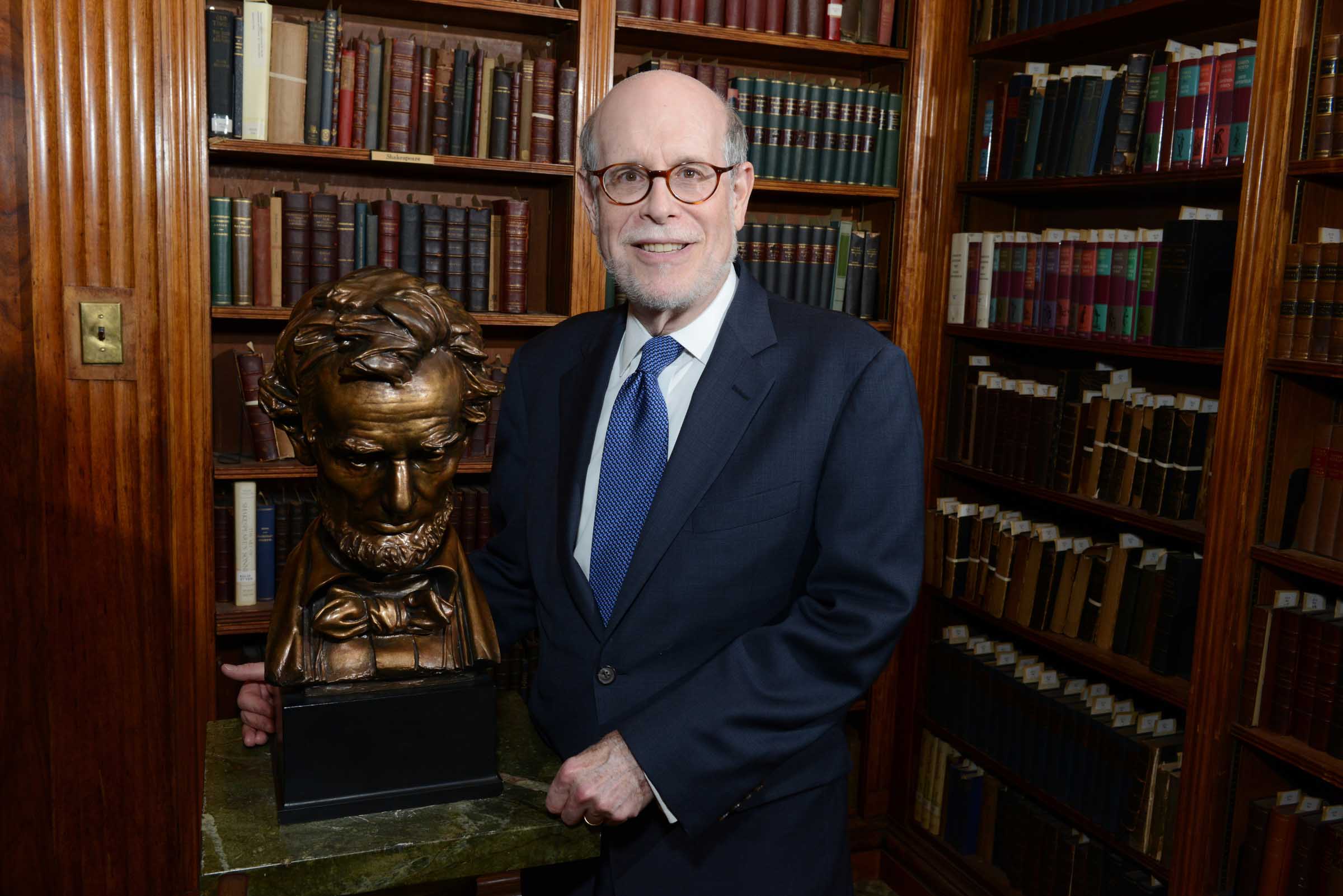 Harold Holzer sitting in a study with books. 