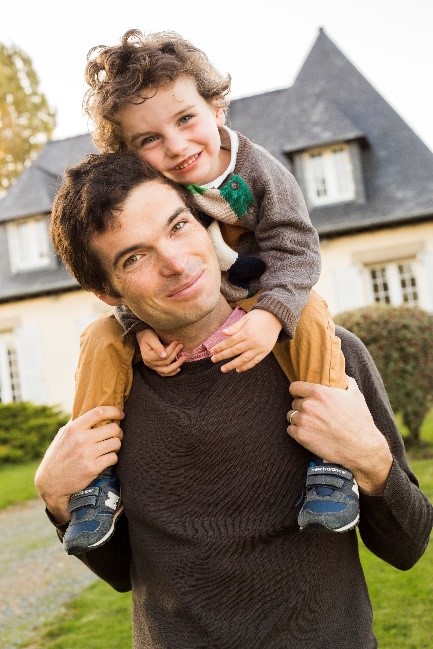 Dr. Ben Abbott with his son on his shoulders.