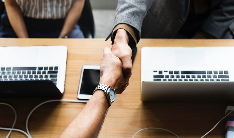 An image of two people shaking hands