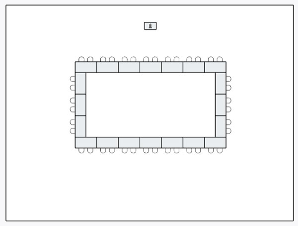 event space set up with rectangular tables set up in a rectangle with chairs around the outside