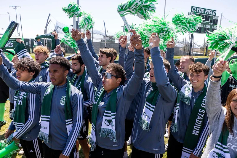 boys soccer team cheering at groundbreaking