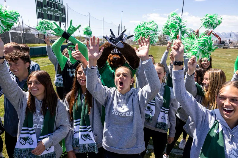 girls soccer team cheering at groundbreaking