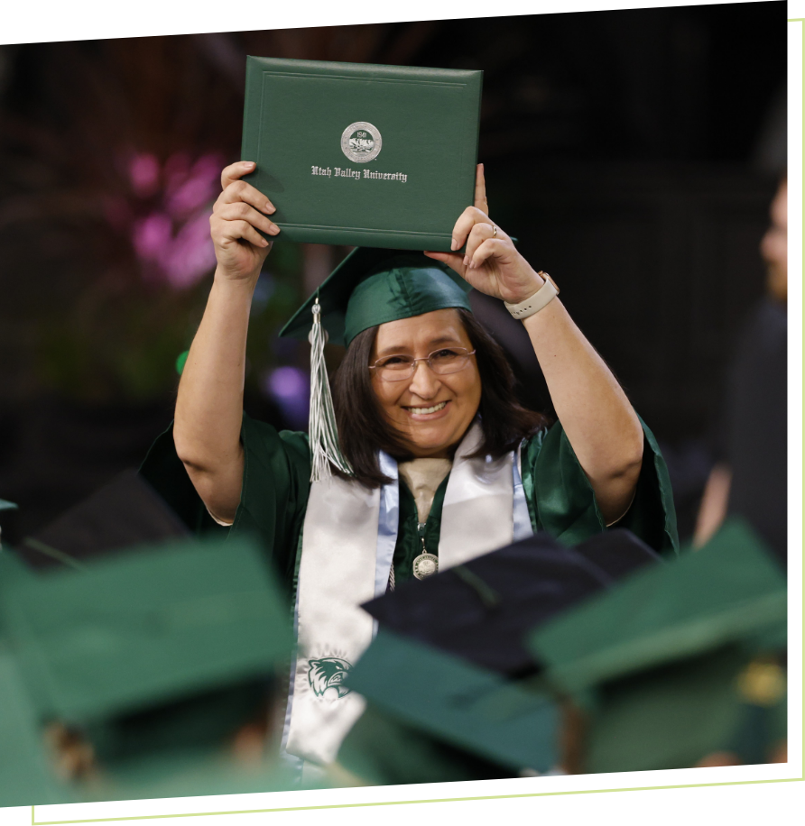 picture of graduate holding up thier diploma
