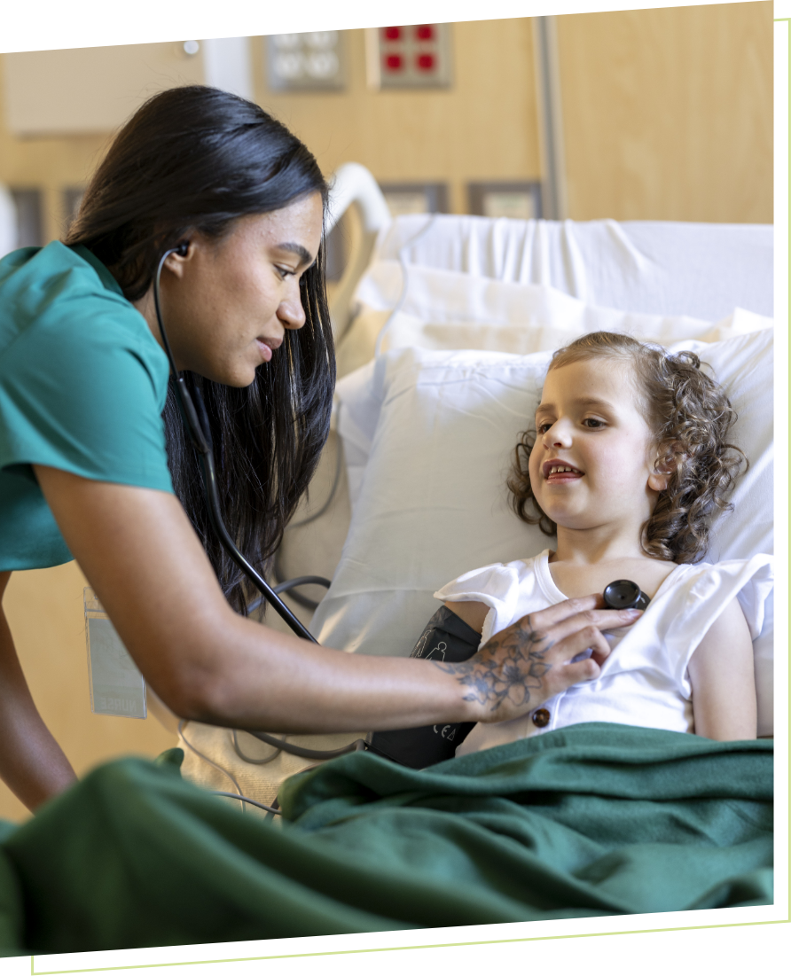 student nurse helping child in hospital bed