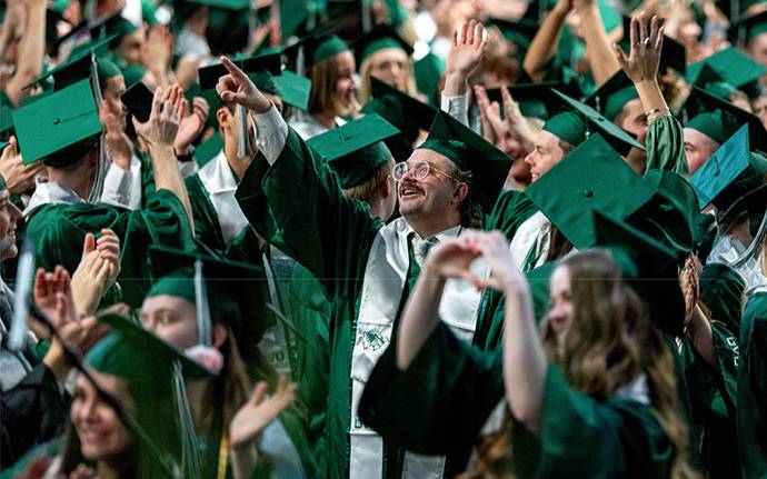 students at commencement in cap and gown