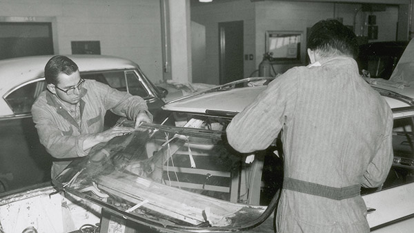 black and white historic image of auto mechanic students