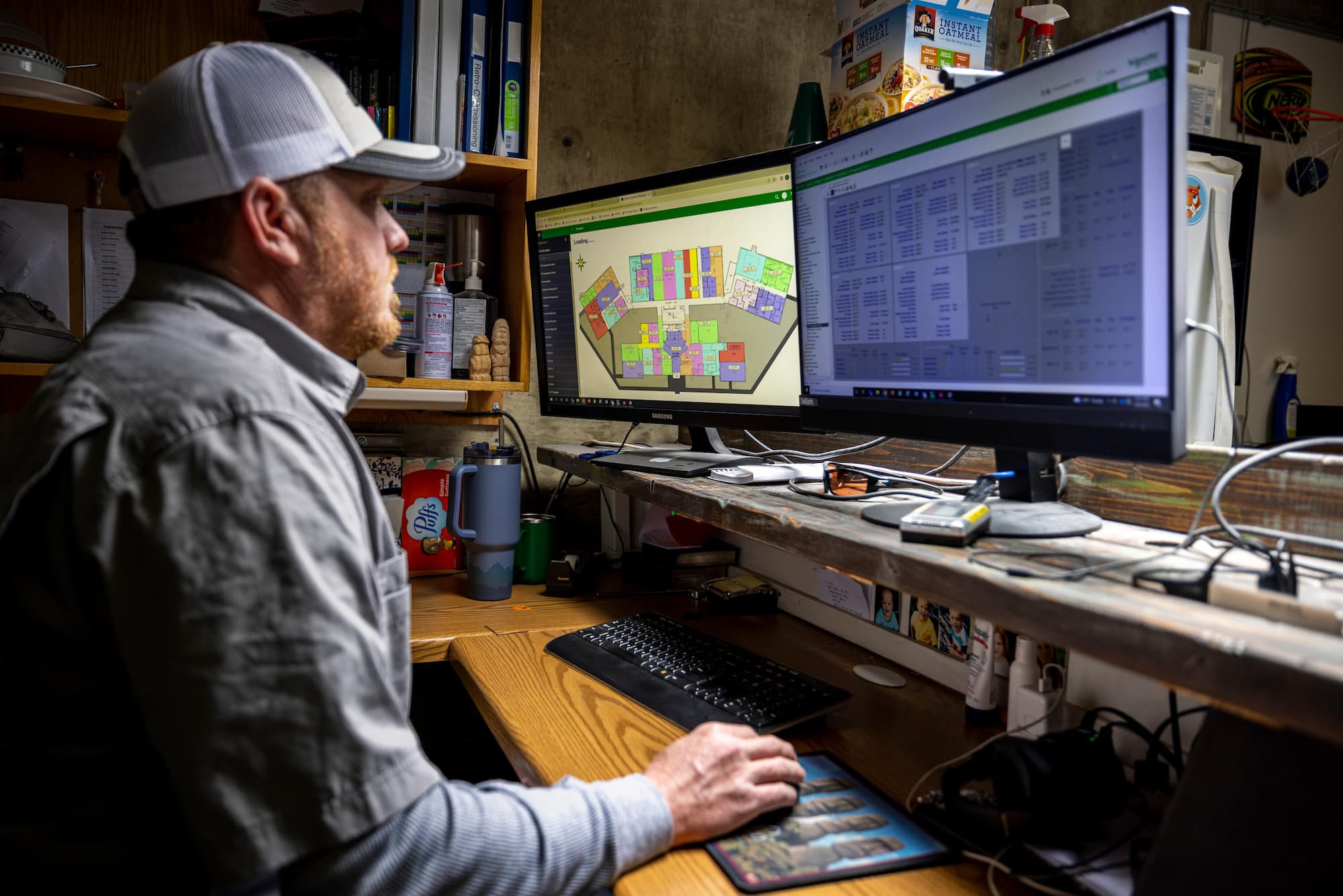 A Building Automation Programmer sitting a desk with two monitors.