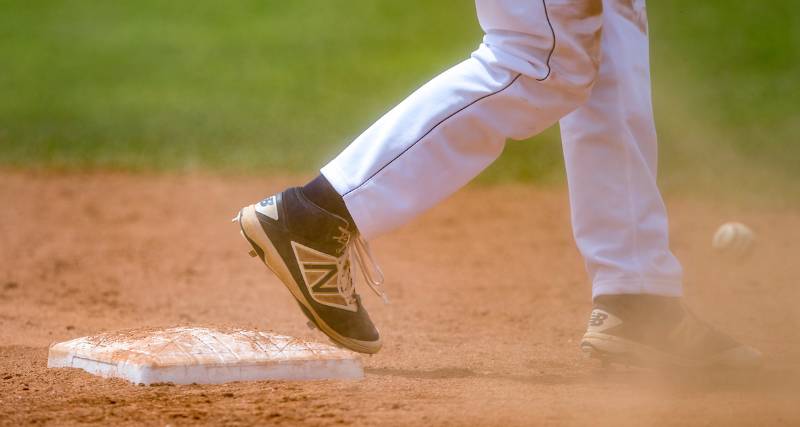 Close-up of baseball player running from base.