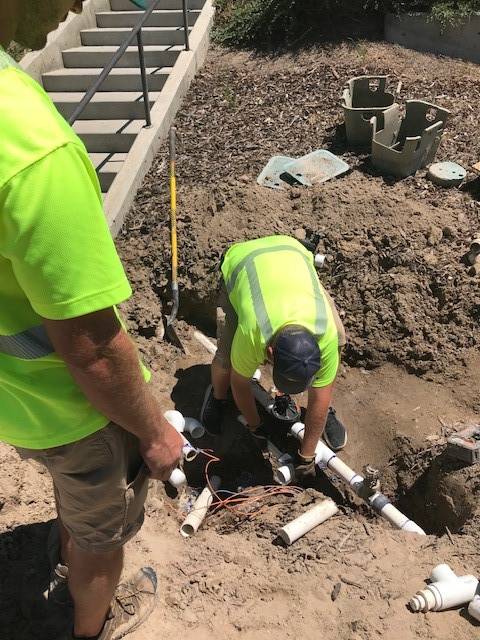 Irrigation team working on installation project.