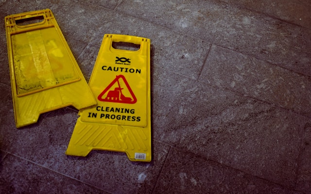 two caution signs laying on the floor