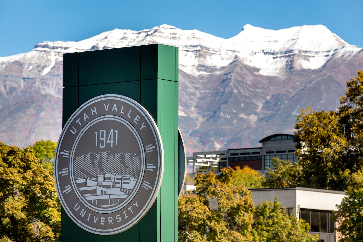 Official main UVU logo sign on campus outside.