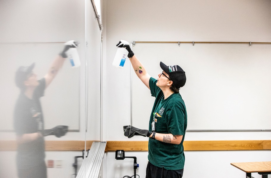 UVU employee cleaning whiteboards