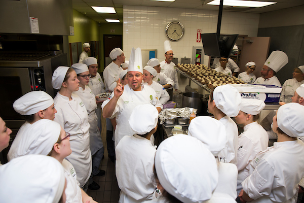 Chef Troy teaching students in the Culinary Arts kitchen.