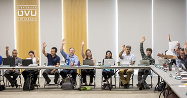 Members of the Senate voting by the raise of a hand.