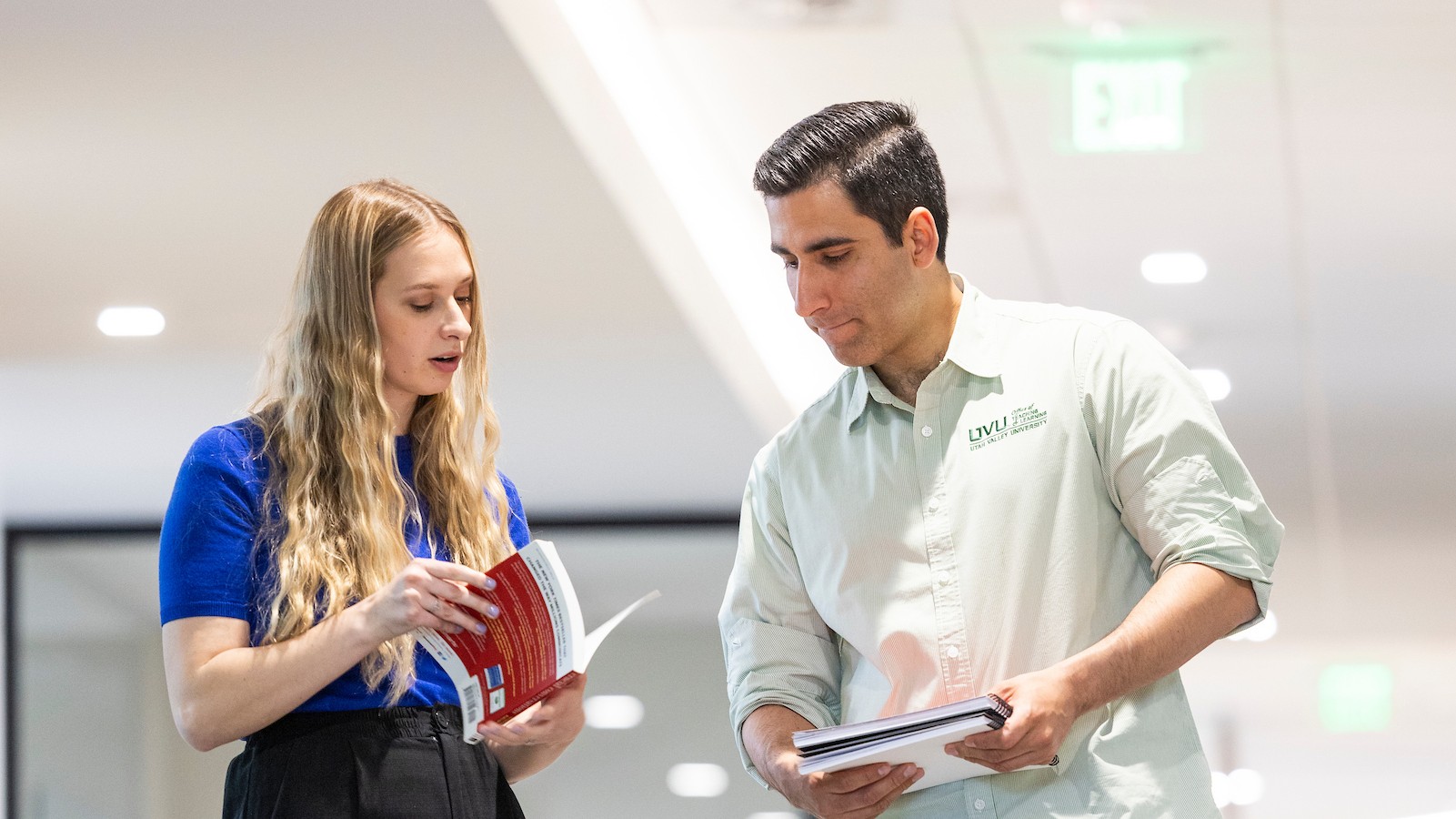 supervisor and employee looking at a book