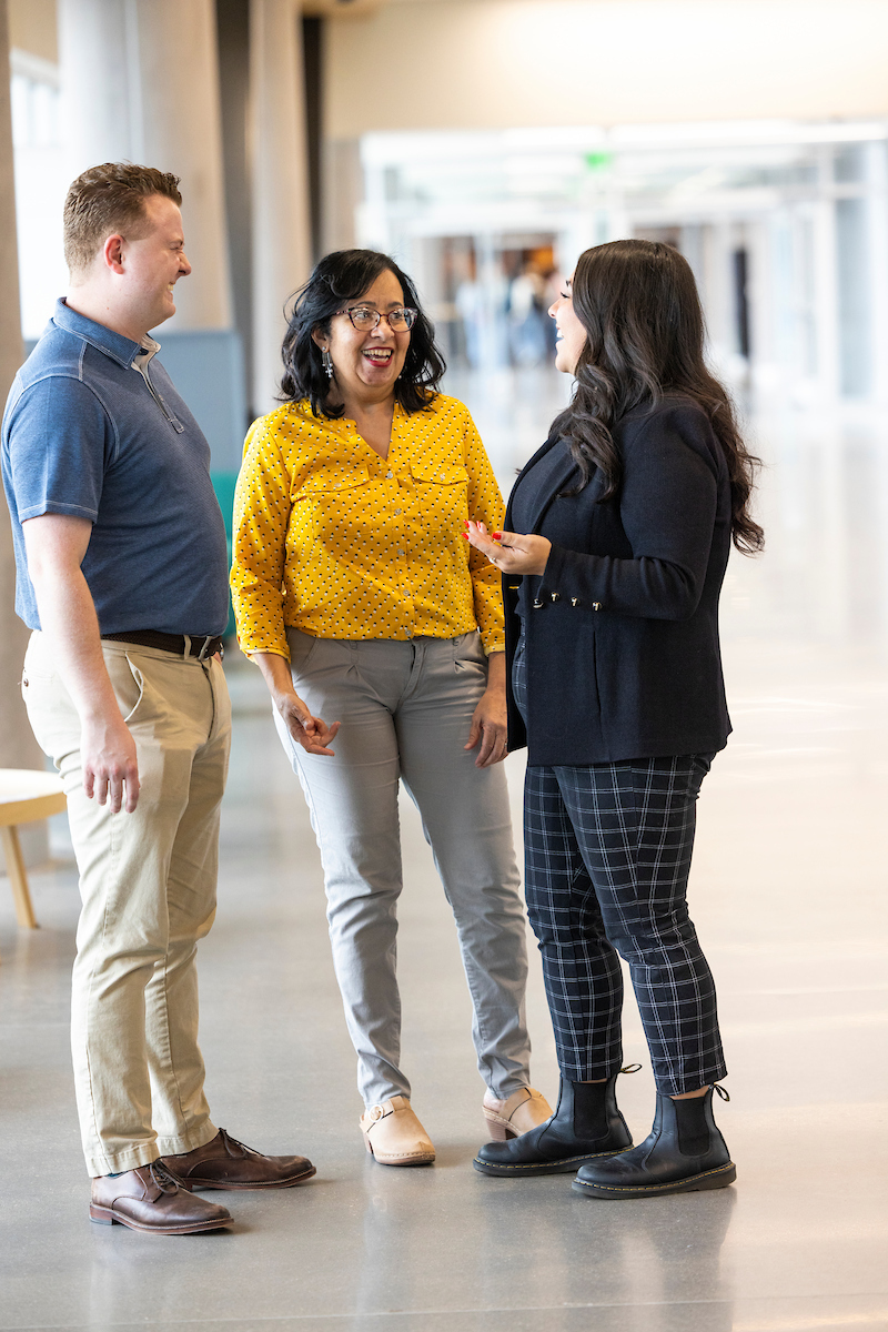 three adults in conversation