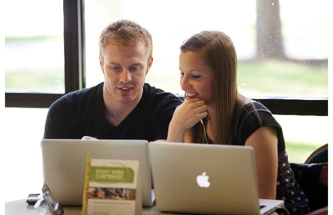 Two people on a computer